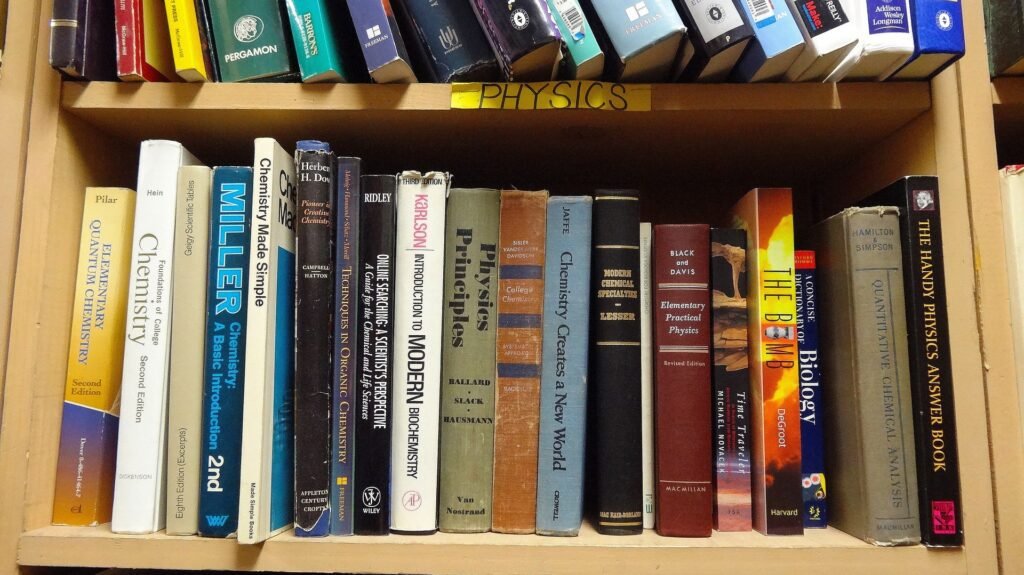 alt="various books on different subject on shelves"