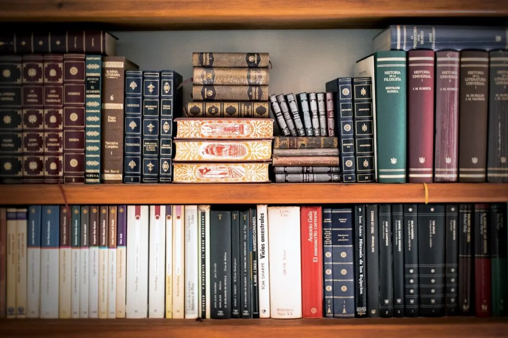 alt="2 level book shelves filled with books on various topic and subjects"