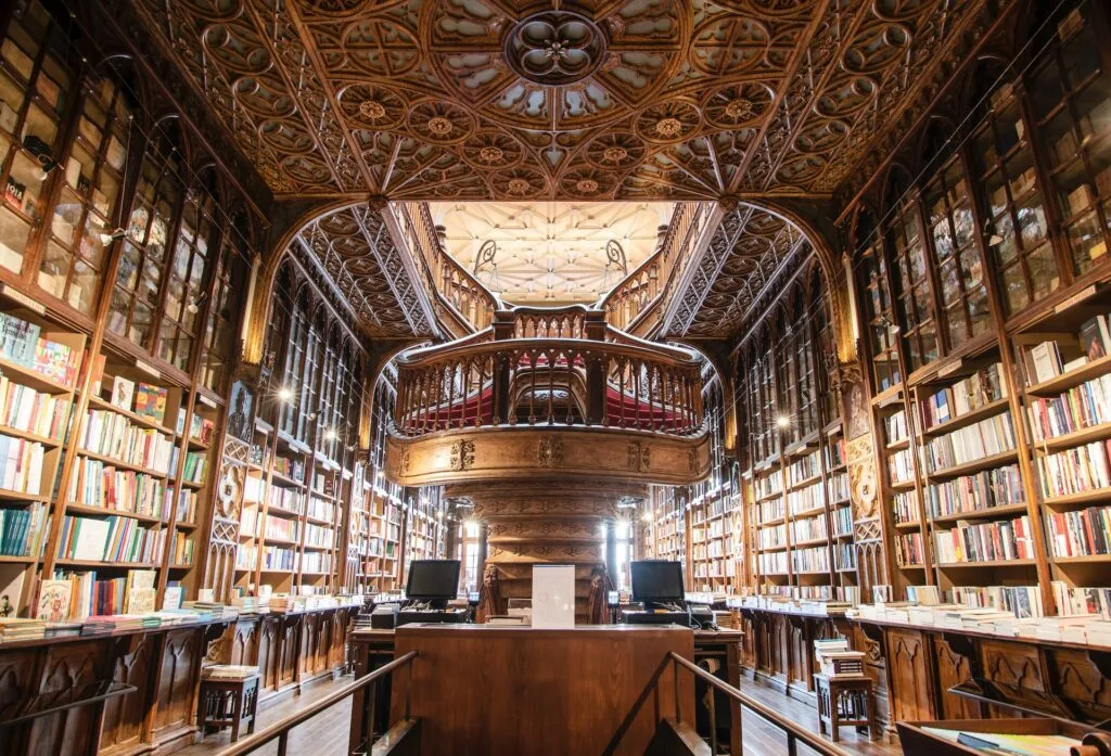 alt="A grand library with gold like decorations filled with Affordable education books"
