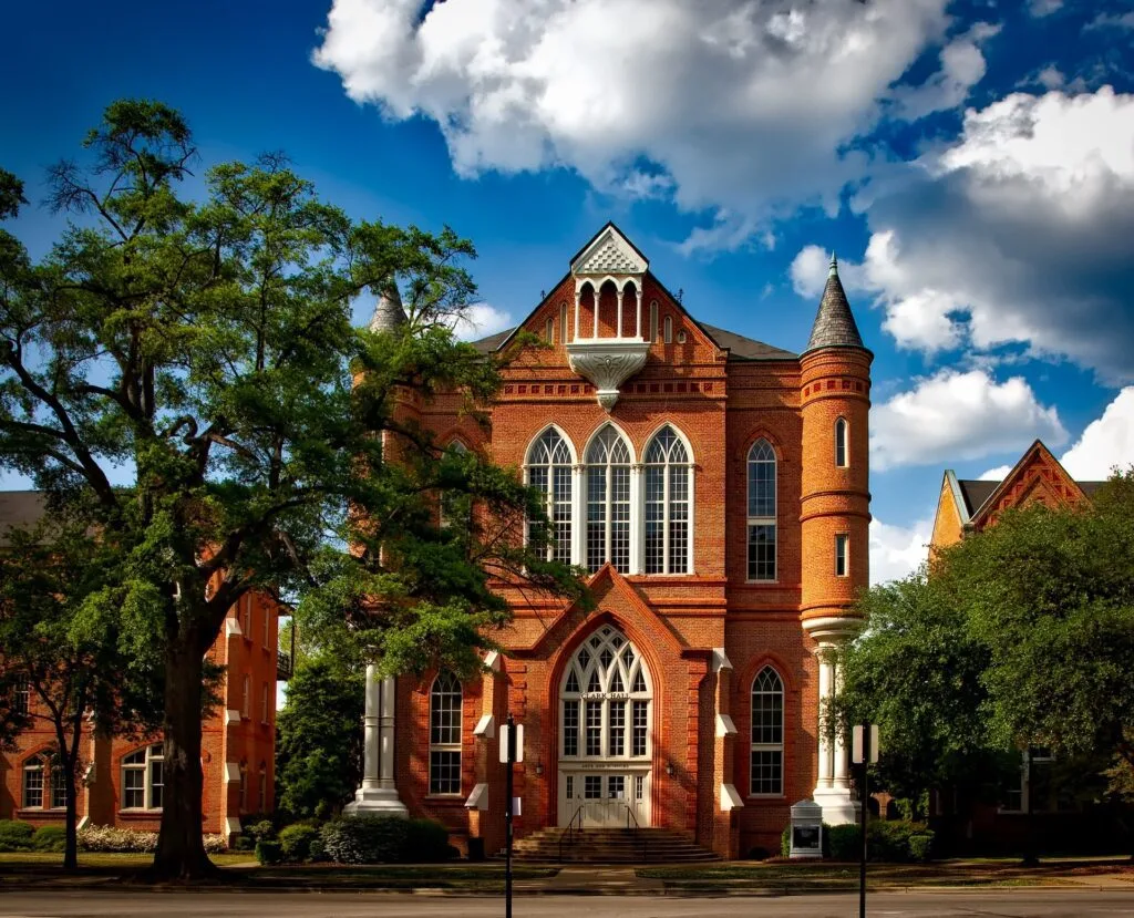 alt="a school building with light brown colors representing education alternatives"